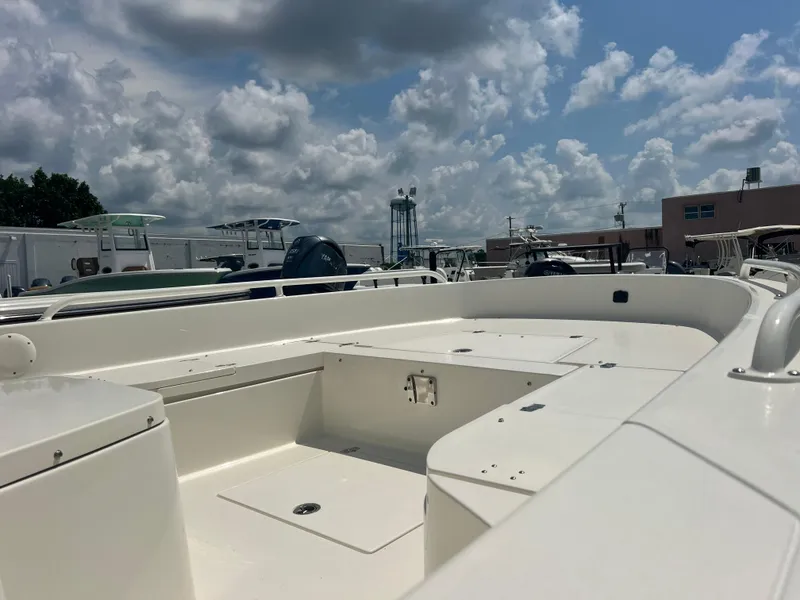 Slide: The Image of 2025 Pathfinder 2600 TRS boat deck under cloudy sky at marina. - 2