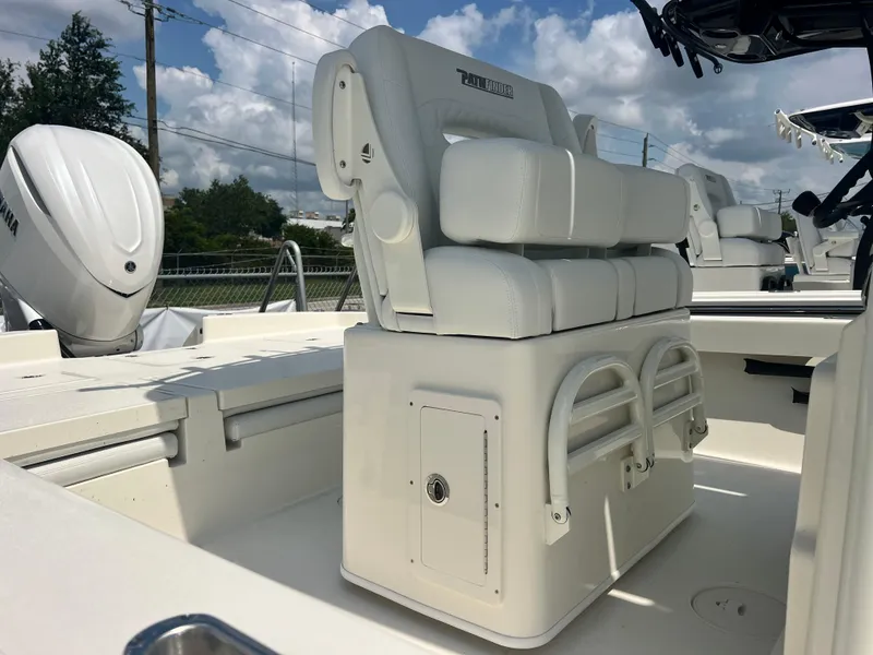 Slide: The Image of 2025 Pathfinder 2600 TRS boat interior with cushioned seating and Yamaha outboard motor. - 4