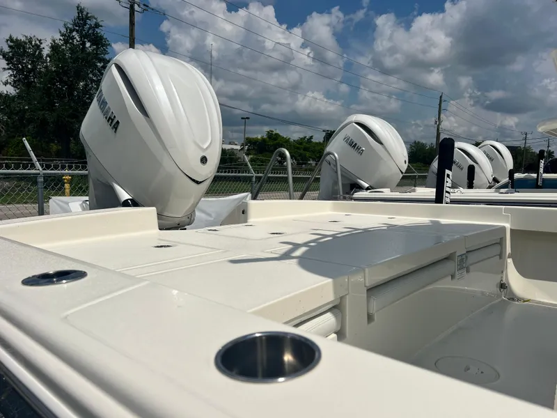 Slide: The Image of 2025 Pathfinder 2600 TRS boat with Yamaha outboard engines, docked under a cloudy sky. - 6