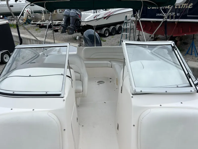 Slide: The Image of 2006 Hurricane SunDeck 237 DC OB boat with open deck and seating area. - 10