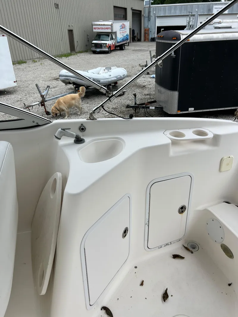 Slide: The Image of 2006 Hurricane SunDeck 237 DC OB interior with sink and storage compartments. - 12