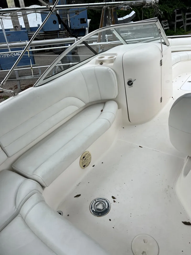 Slide: The Image of 2006 Hurricane SunDeck 237 DC OB boat interior with white seating and storage compartment. - 13