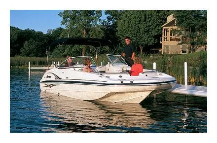 Slide: The Image of 2006 Hurricane SunDeck 237 DC OB boat docked on a serene lake. - 15