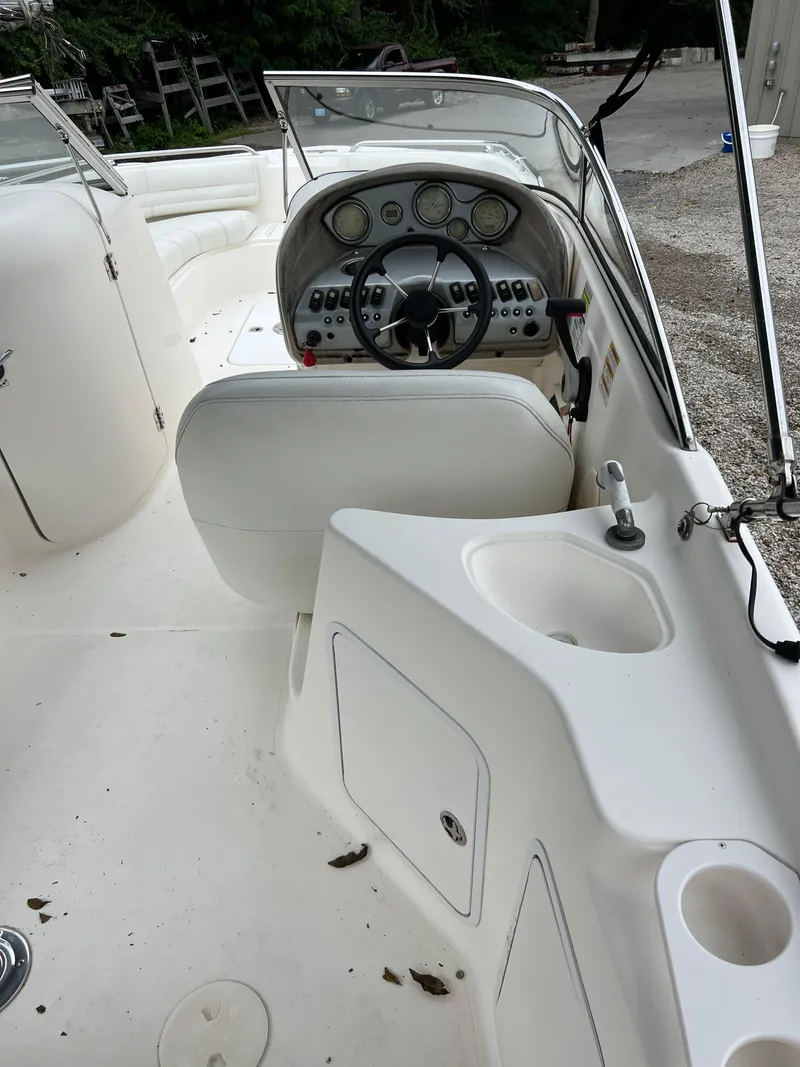 Slide: The Image of 2006 Hurricane SunDeck 237 DC OB boat interior with steering wheel and dashboard. - 7