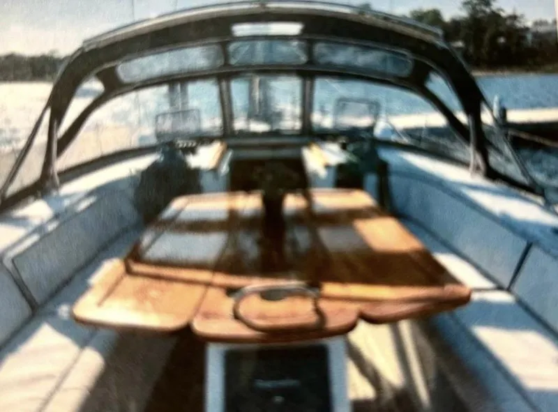 Slide: The Image of 2007 Beneteau Oceanis Clipper 523 yacht cockpit with wooden table and seating. - 12