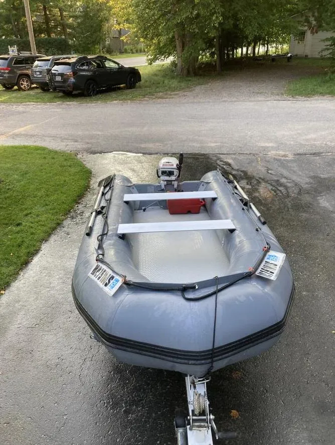 Slide: The Image of Inflatable boat on trailer, parked outdoors; associated with 2007 Beneteau Oceanis Clipper 523. - 14