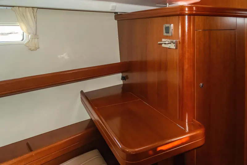Slide: The Image of Interior of 2007 Beneteau Oceanis Clipper 523, featuring polished wood cabinetry and a small window. - 20