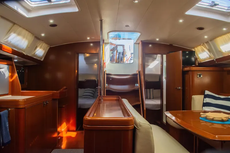 Slide: The Image of Interior of 2007 Beneteau Oceanis Clipper 523 yacht, featuring cozy cabins and elegant wood finishes. - 21
