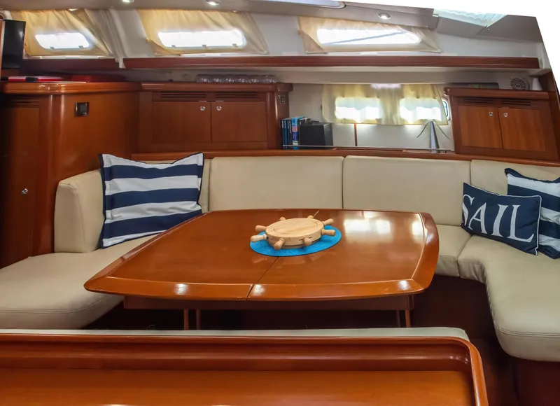 Slide: The Image of Interior of 2007 Beneteau Oceanis Clipper 523 yacht with cozy seating and nautical decor. - 23