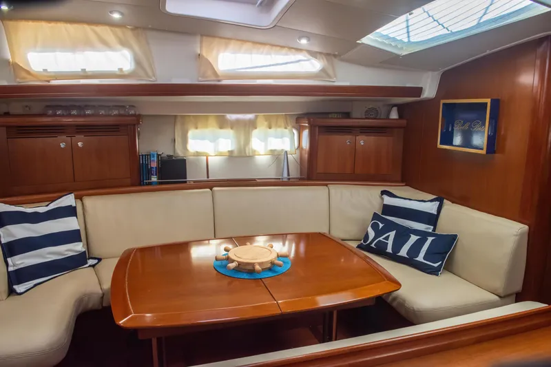 Slide: The Image of Interior of 2007 Beneteau Oceanis Clipper 523 yacht with cozy seating and nautical decor. - 24