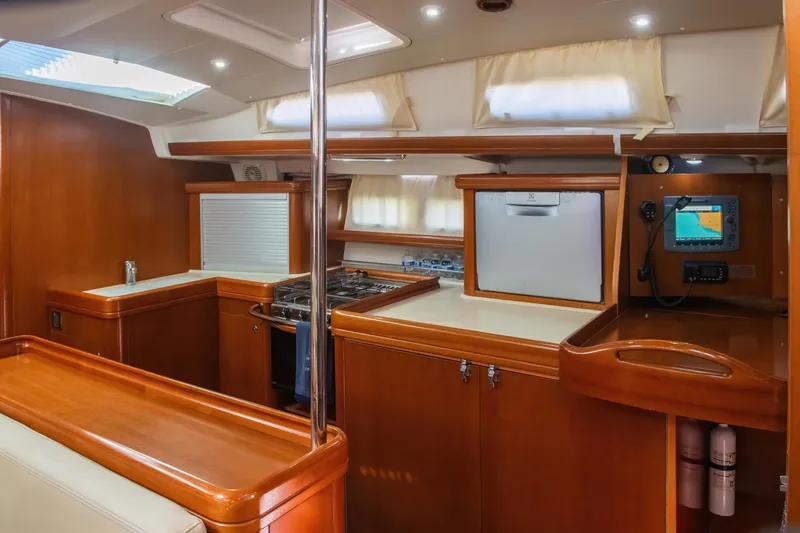 Slide: The Image of Interior of 2007 Beneteau Oceanis Clipper 523 yacht, featuring a modern kitchen area. - 25