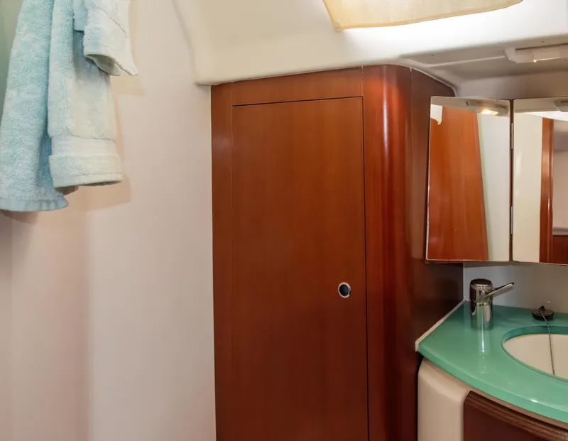 Slide: The Image of Interior of 2007 Beneteau Oceanis Clipper 523 yacht bathroom with wooden cabinetry and modern sink. - 26