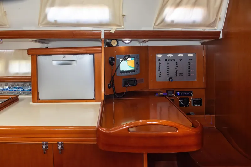 Slide: The Image of Interior of 2007 Beneteau Oceanis Clipper 523 yacht with navigation panel and wooden cabinetry. - 27