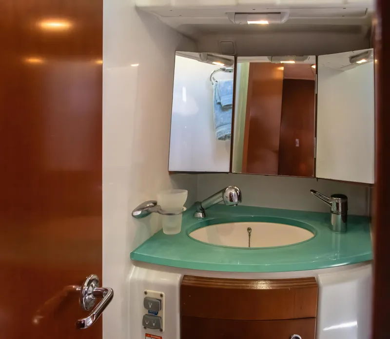 Slide: The Image of Bathroom vanity in 2007 Beneteau Oceanis Clipper 523 yacht with turquoise countertop. - 29