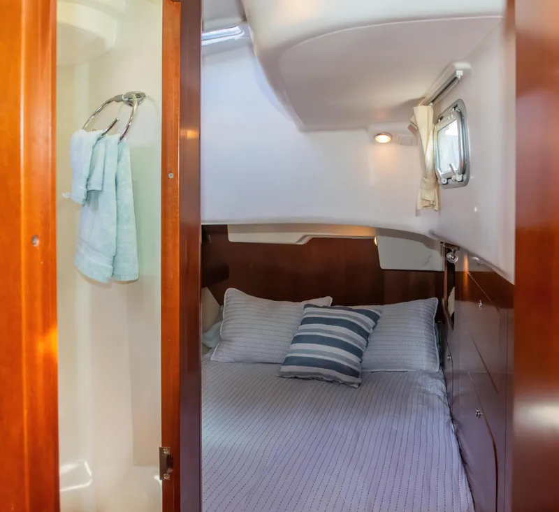 Slide: The Image of Cozy cabin interior of 2007 Beneteau Oceanis Clipper 523 yacht with bed and towels. - 31