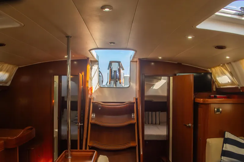 Slide: The Image of Interior of 2007 Beneteau Oceanis Clipper 523 yacht, featuring cozy cabins and elegant wood finishes. - 32