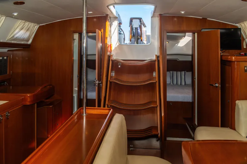 Slide: The Image of Interior of 2007 Beneteau Oceanis Clipper 523 yacht, featuring wood finishes and cozy seating. - 33