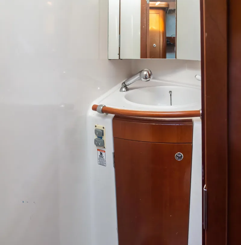 Slide: The Image of 2007 Beneteau Oceanis Clipper 523 bathroom with wooden vanity and mirror. - 37