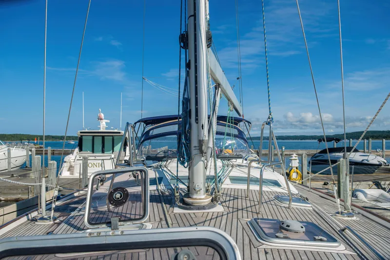 Slide: The Image of 2007 Beneteau Oceanis Clipper 523 sailboat docked, showcasing deck and mast under clear blue sky. - 40