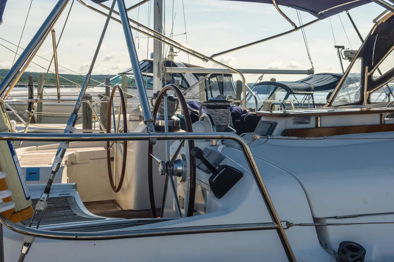 Slide: The Image of 2007 Beneteau Oceanis Clipper 523 sailboat cockpit with dual steering wheels in marina. - 47