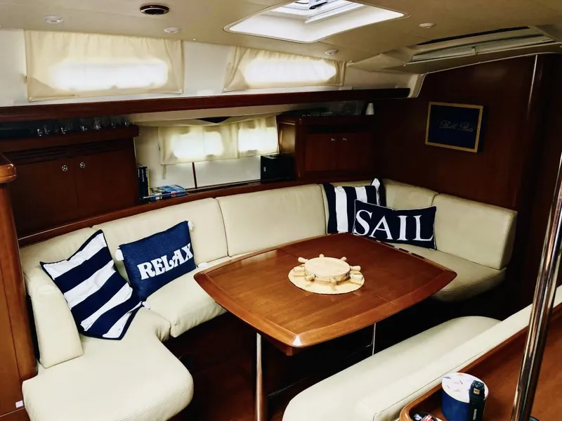 Slide: The Image of Interior of 2007 Beneteau Oceanis Clipper 523 with cozy seating and nautical decor. - 5