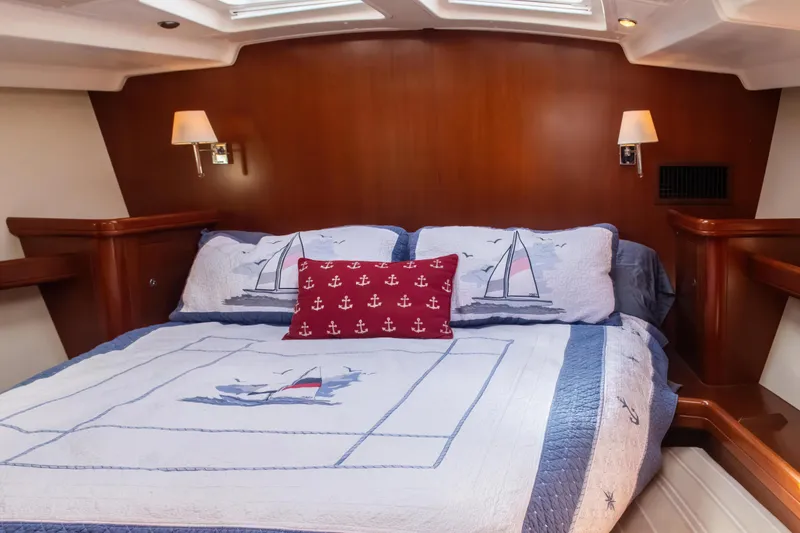 Slide: The Image of Luxurious cabin interior of 2007 Beneteau Oceanis Clipper 523 yacht with nautical-themed bedding. - 7