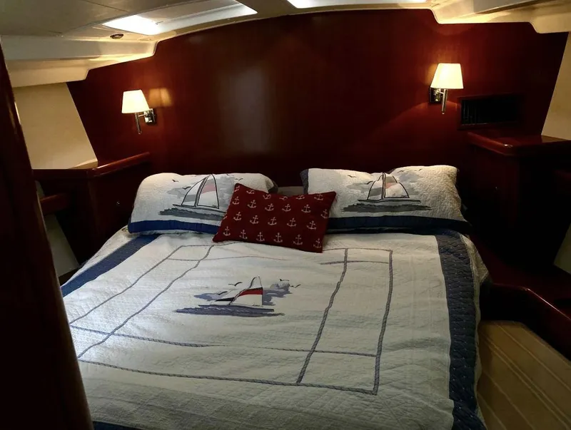Slide: The Image of Luxurious cabin interior of 2007 Beneteau Oceanis Clipper 523 with nautical-themed bedding. - 8