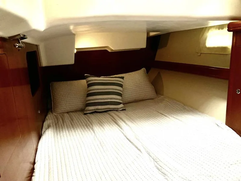 Slide: The Image of Cozy cabin interior of 2007 Beneteau Oceanis Clipper 523 with striped pillow and wooden accents. - 9