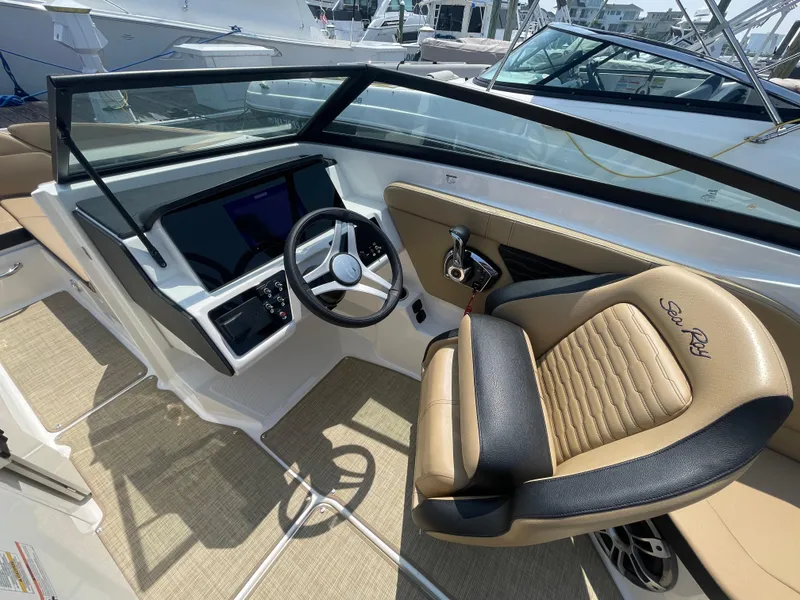 Slide: The Image of 2023 Sea Ray SPX 230 Outboard cockpit with steering wheel and luxurious seating. - 11