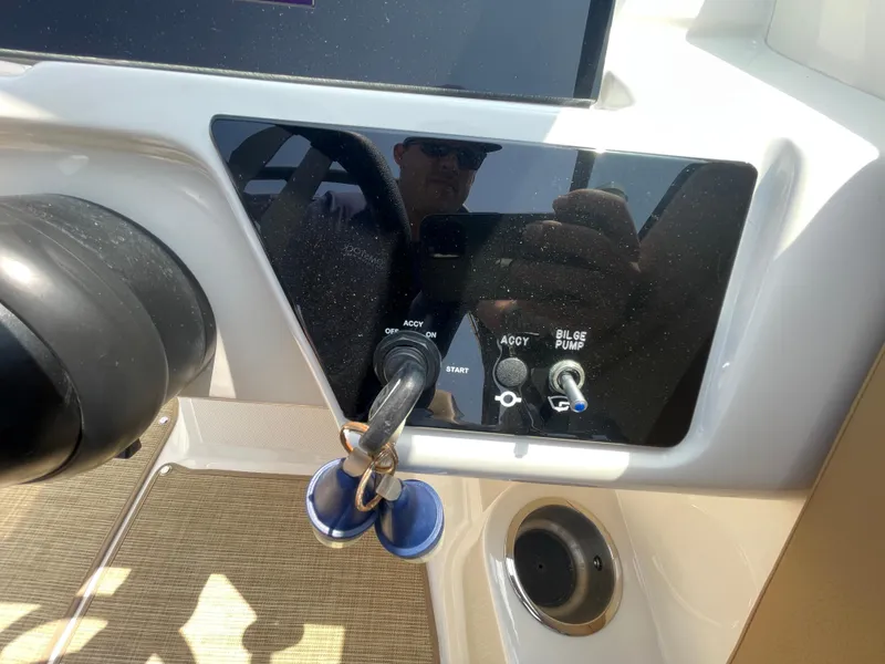 Slide: The Image of Control panel of 2023 Sea Ray SPX 230 Outboard with ignition and bilge pump switches. - 16