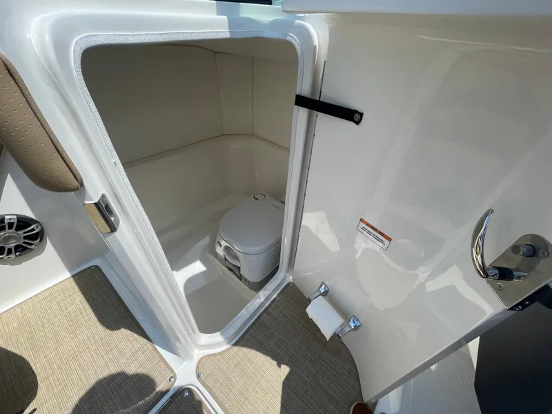 Slide: The Image of 2023 Sea Ray SPX 230 Outboard boat interior with compact toilet compartment. - 19