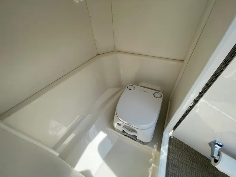 Slide: The Image of 2023 Sea Ray SPX 230 Outboard boat interior with compact marine toilet. - 20