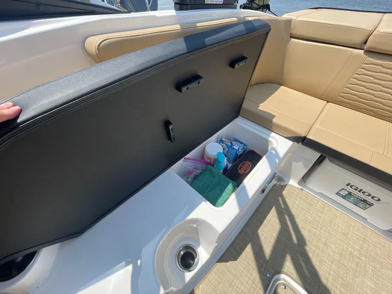 Slide: The Image of 2023 Sea Ray SPX 230 Outboard boat storage compartment with various items inside. - 24