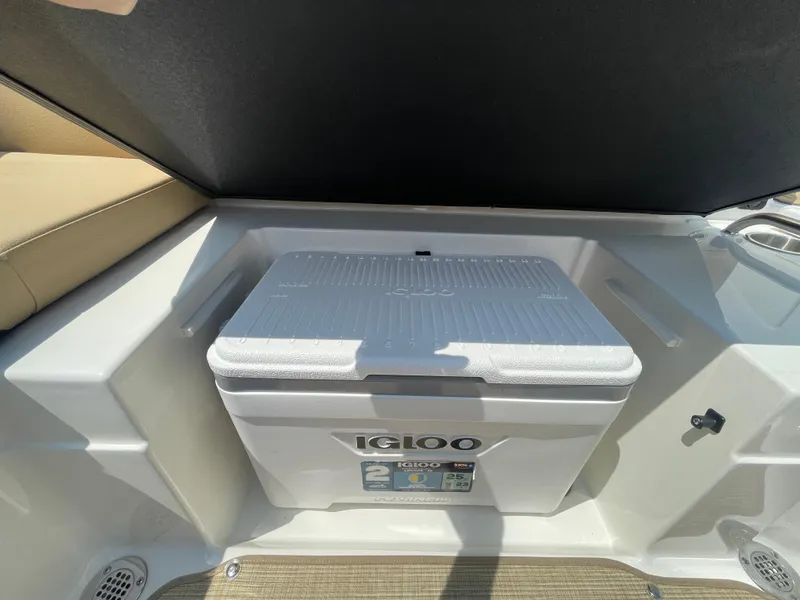 Slide: The Image of 2023 Sea Ray SPX 230 Outboard with Igloo cooler in storage compartment. - 26