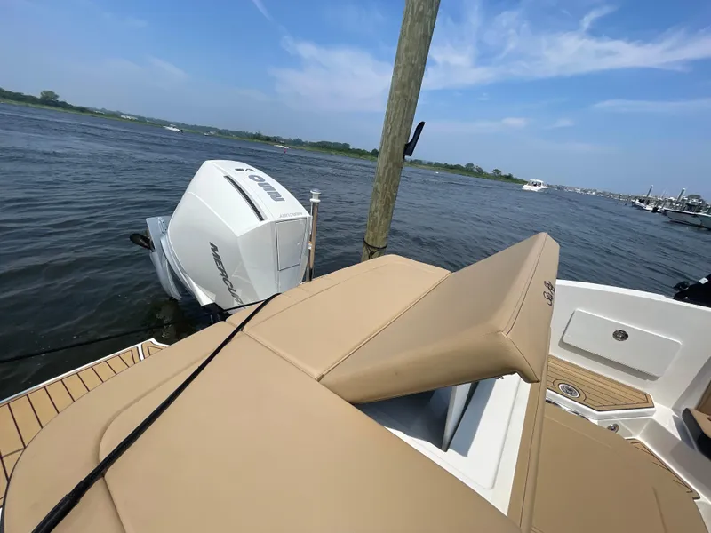 Slide: The Image of 2023 Sea Ray SPX 230 Outboard boat docked, featuring a Mercury engine. - 31