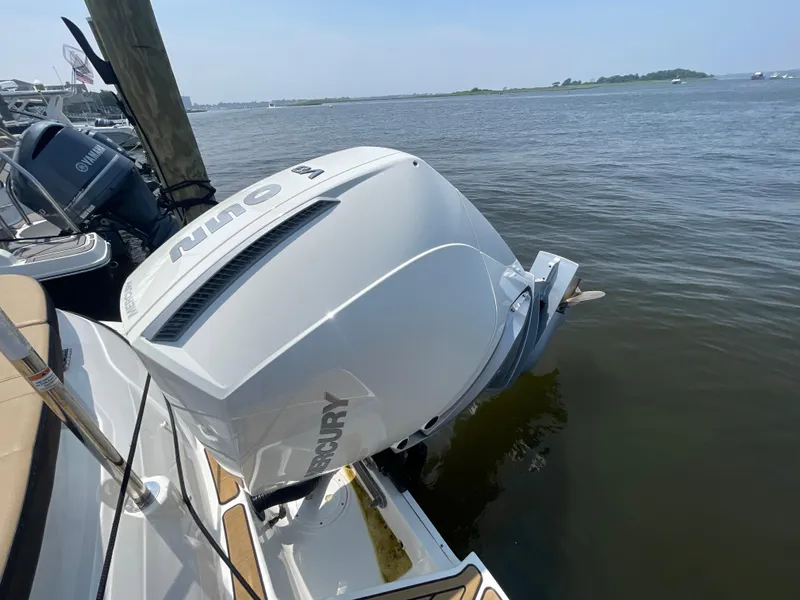 Slide: The Image of 2023 Sea Ray SPX 230 Outboard with Mercury engine docked by the water. - 34