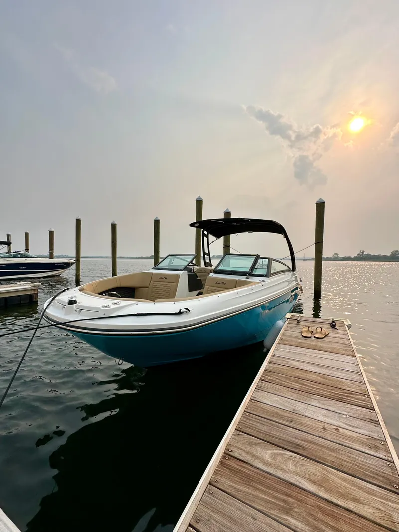 Slide: The Image of 2023 Sea Ray SPX 230 OB docked at sunset, calm waters. - 39