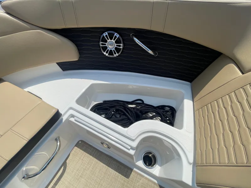 Slide: The Image of 2023 Sea Ray SPX 230 Outboard interior with storage compartment and speaker. - 8