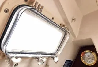 Slide: The Image of Interior of 1984 Hunter 31 sailboat with porthole and clock. - 16