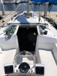 Slide: The Image of 1984 Hunter 31 sailboat cockpit with ropes and navigation equipment at marina. - 25