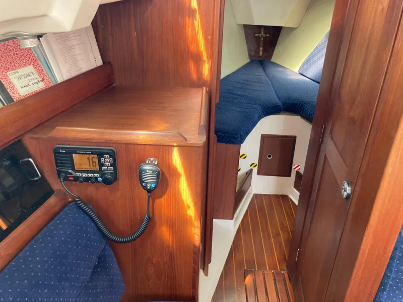 Slide: The Image of Interior of 1984 Hunter 31 sailboat with wood paneling and VHF radio. - 28