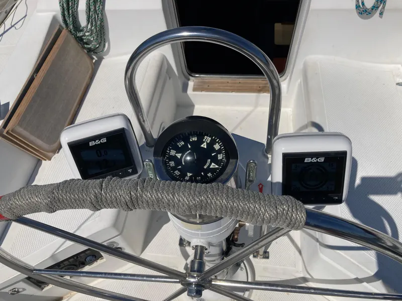 Slide: The Image of 1984 Hunter 31 sailboat cockpit with compass and B&G instruments. - 33