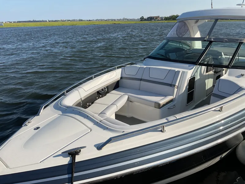 The Image of 2022 Formula 350 Crossover Bowrider I/O on calm water, showcasing sleek design and spacious seating. - 0
