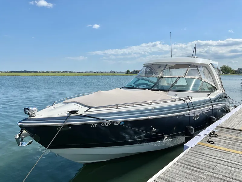 Slide: The Image of 2022 Formula 350 Crossover Bowrider I/O docked on a sunny day. - 1