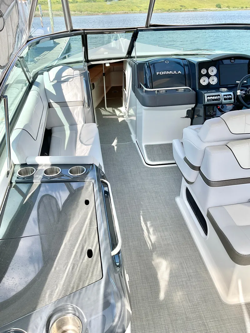 Slide: The Image of 2022 Formula 350 Crossover Bowrider I/O interior with seating and dashboard view. - 10