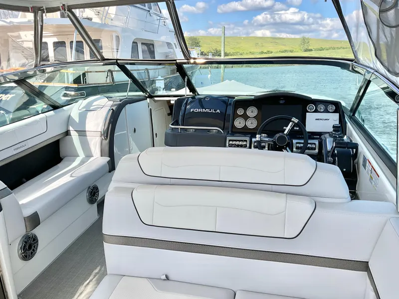 Slide: The Image of 2022 Formula 350 Crossover Bowrider I/O interior with luxurious seating and modern dashboard. - 11