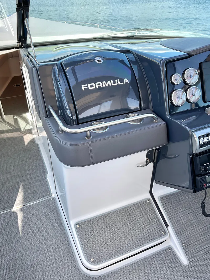 Slide: The Image of 2022 Formula 350 Crossover Bowrider I/O helm with sleek dashboard and controls. - 13
