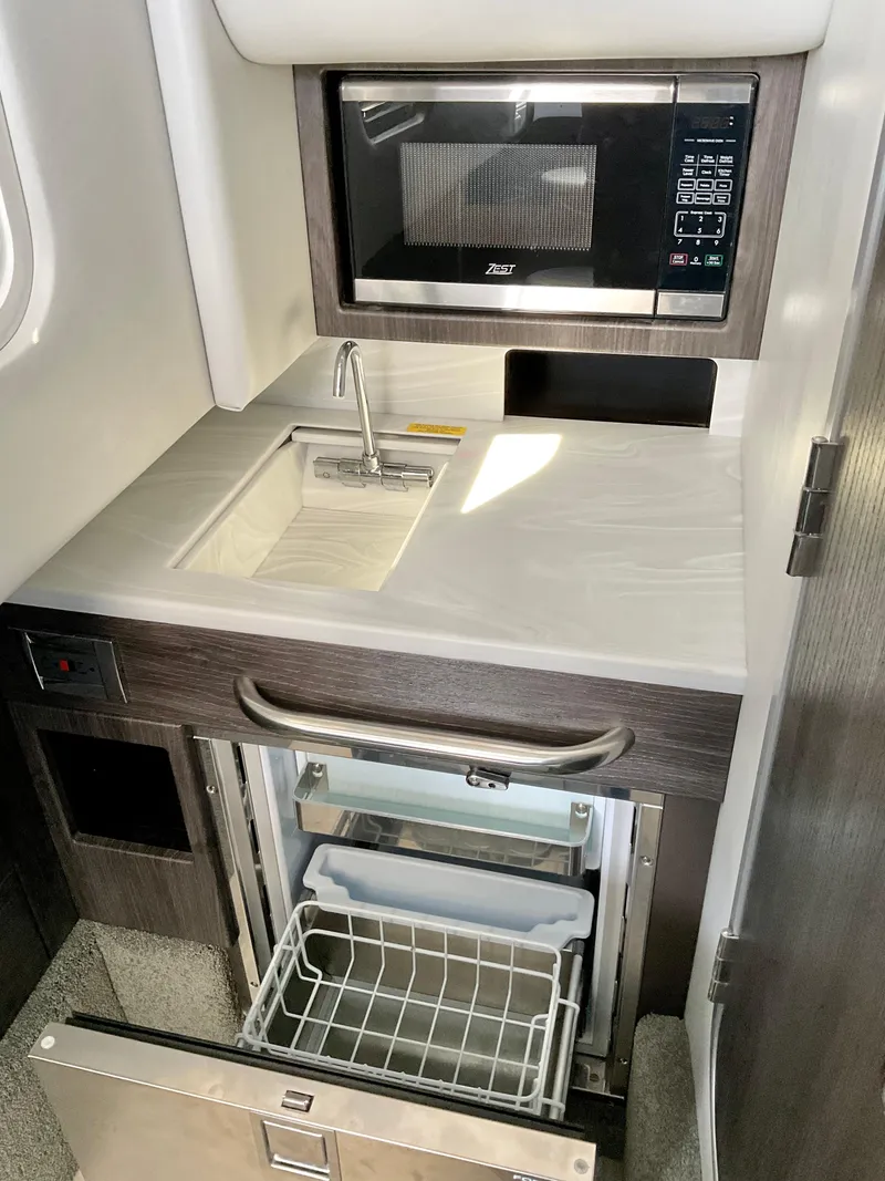 Slide: The Image of Compact kitchenette in 2022 Formula 350 Crossover Bowrider I/O with microwave and sink. - 16