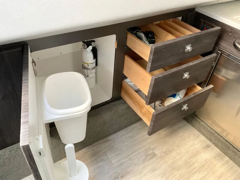 Slide: The Image of 2022 Formula 350 Crossover Bowrider I/O interior with open drawers and storage. - 17