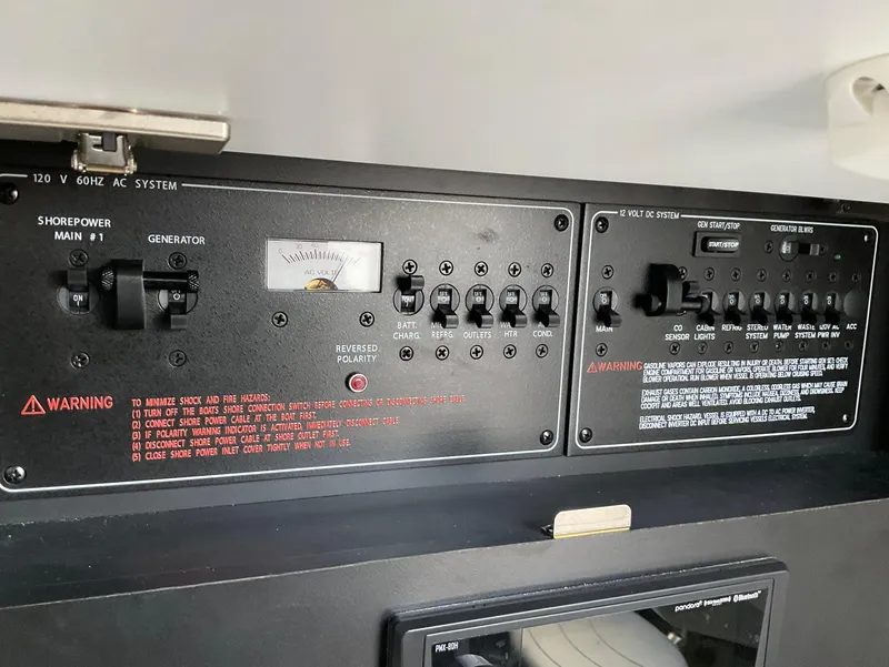 Slide: The Image of Control panel of 2022 Formula 350 Crossover Bowrider I/O boat, featuring switches and warnings. - 23